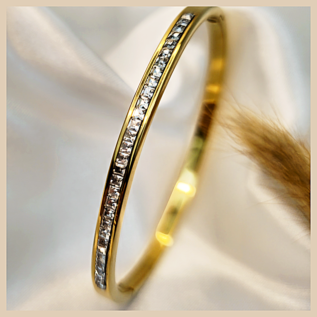 Alma cubic zirconia bangle in gold-tone plated finish, an adjustable bracelet for women that adds refined sparkle to everyday UAE styling.