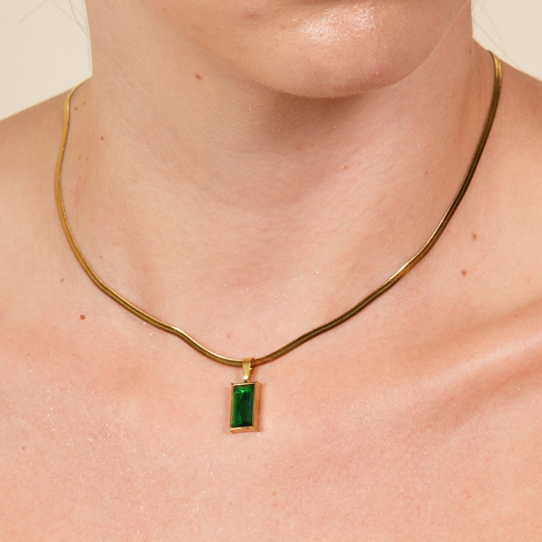 Amor rectangular green necklace with a cubic zirconia pendant and gold chain, designed for women who love elegant color and polished everyday luxury in the UAE.