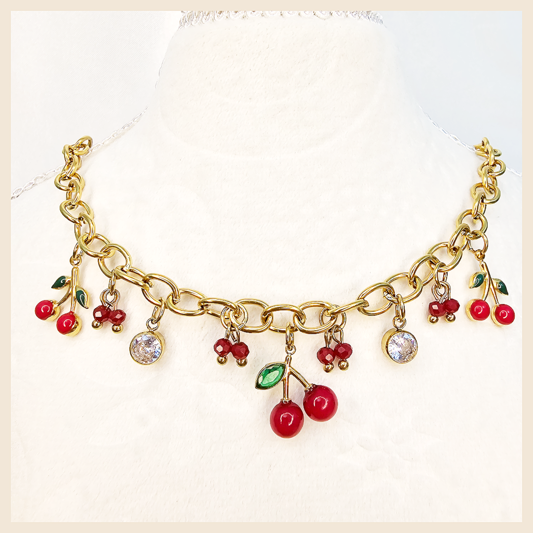 Bina golden cherry necklace with pink and green zircon inlay, a fashionable jewellery gift for women who love sweet elegance and premium feminine detail.