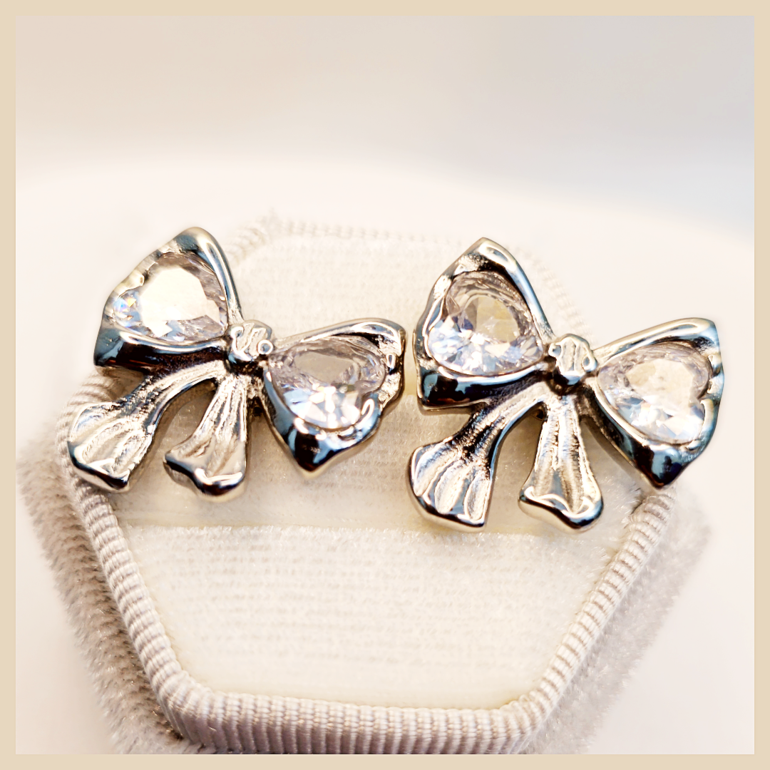Cadi silver bow hoop earrings for women with a bowknot drop design, a charming pair that adds graceful shine and feminine elegance to UAE styling.