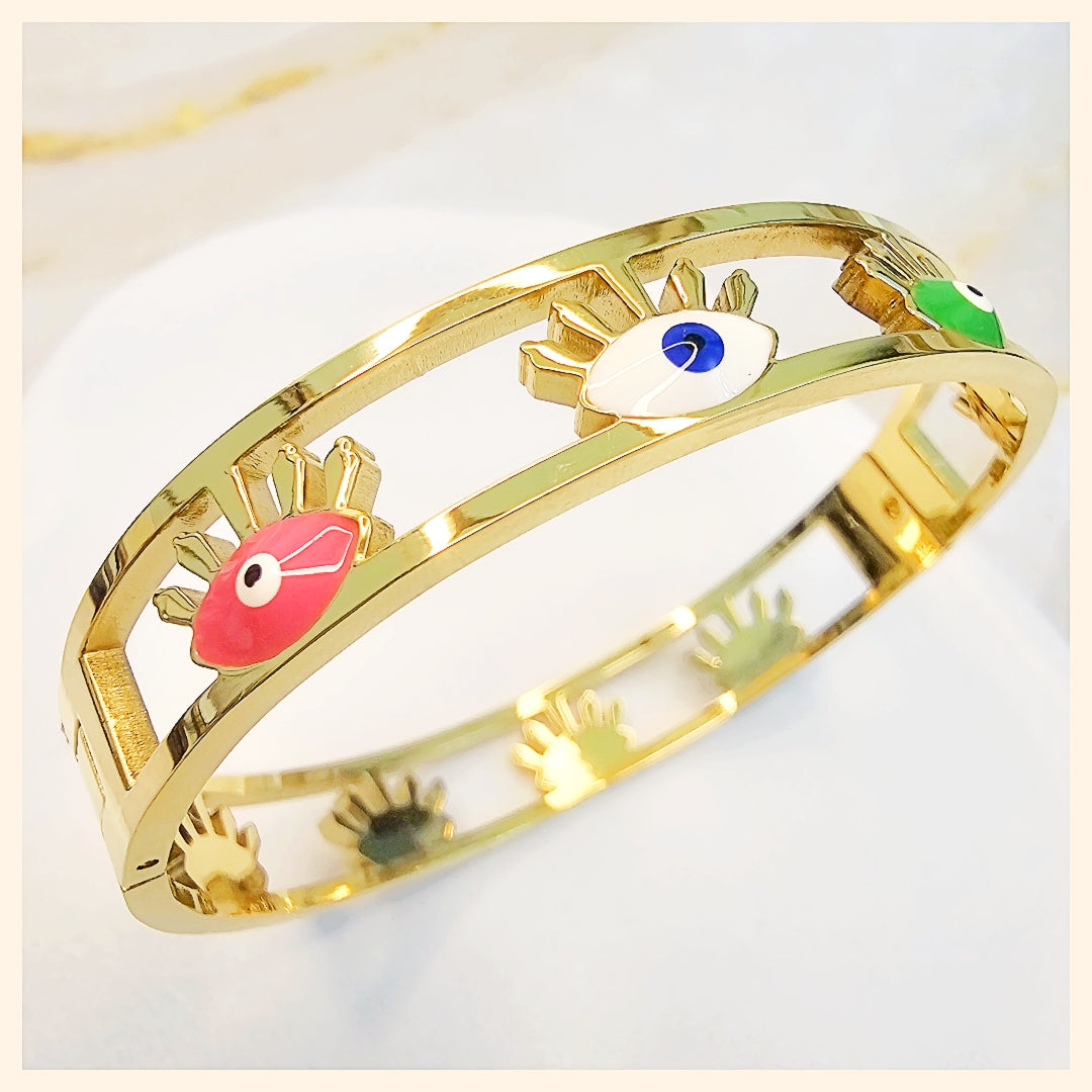 Cuban link gold bracelet with an eye charm, blending modern style with a premium look that feels both bold and feminine.