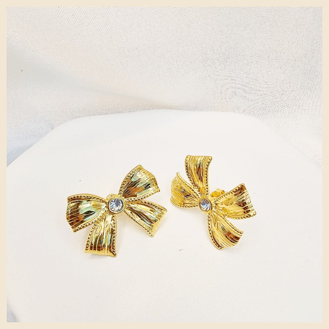 Delicate Lala silver bow tie drop earrings with crystal sparkle, designed for daily luxury styling with a subtle yet eye-catching feminine finish.
