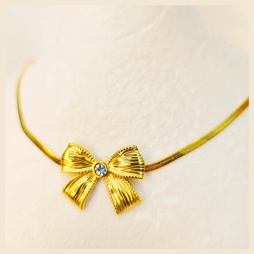 Elegant Lala bow pendant necklace in gold-plated finish, a beautiful gift for her for birthdays, anniversaries, or a thoughtful surprise.