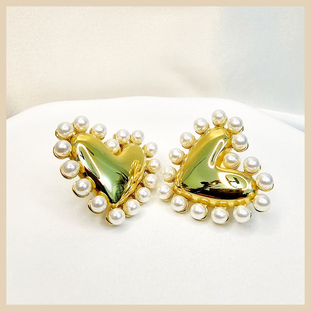 Fara heart-shaped pearl drop earrings in gold color, party-ready for women who want a flattering glow and a charming statement detail.