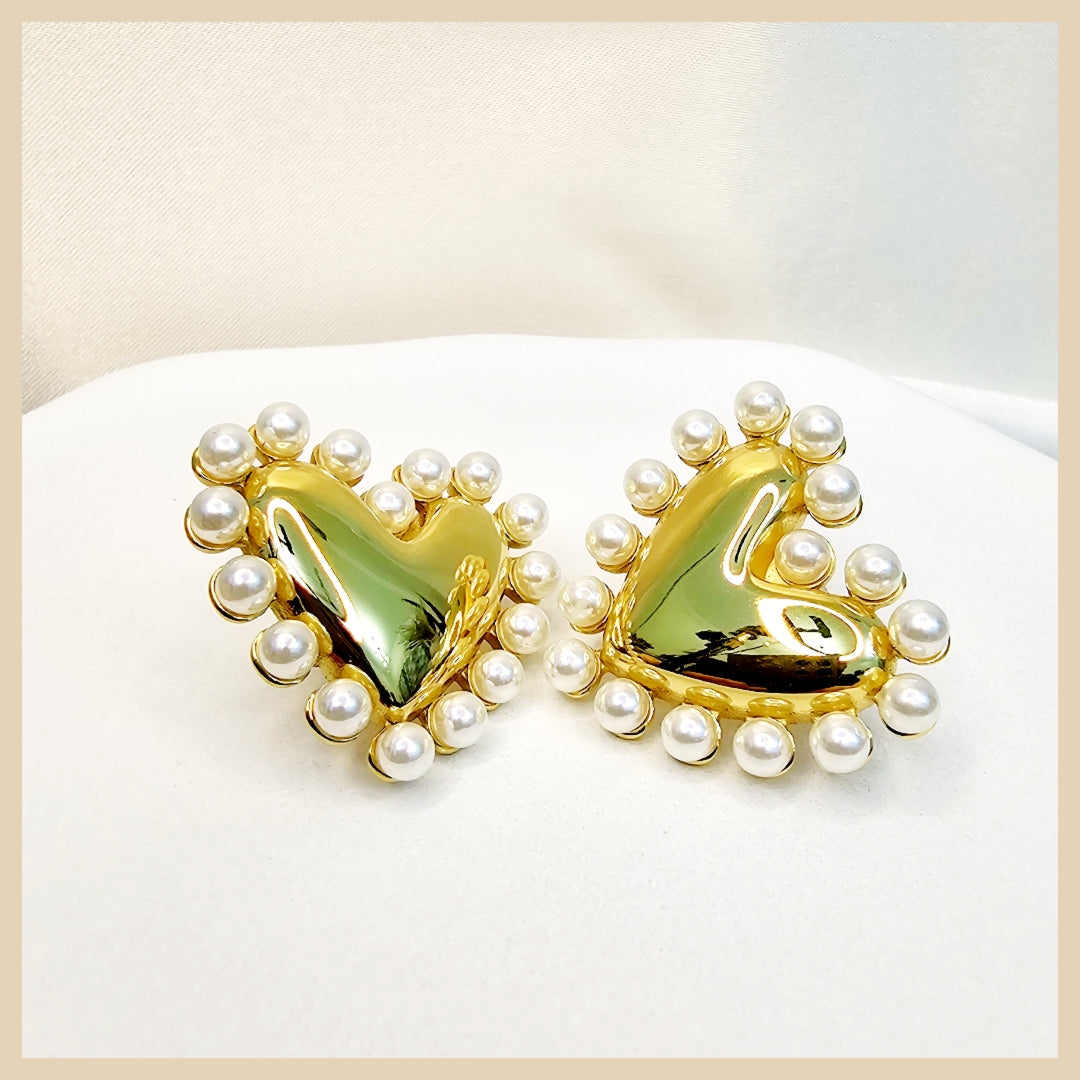 Fara heart-shaped pearl drop earrings in gold color, party-ready for women who want a flattering glow and a charming statement detail.