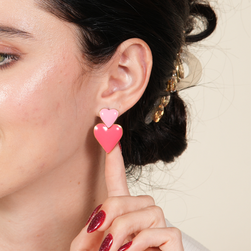 18K gold heart dangle earrings in a luxe Dubai setting, offering a rich glow that reflects refined taste and confidence for women shoppers.