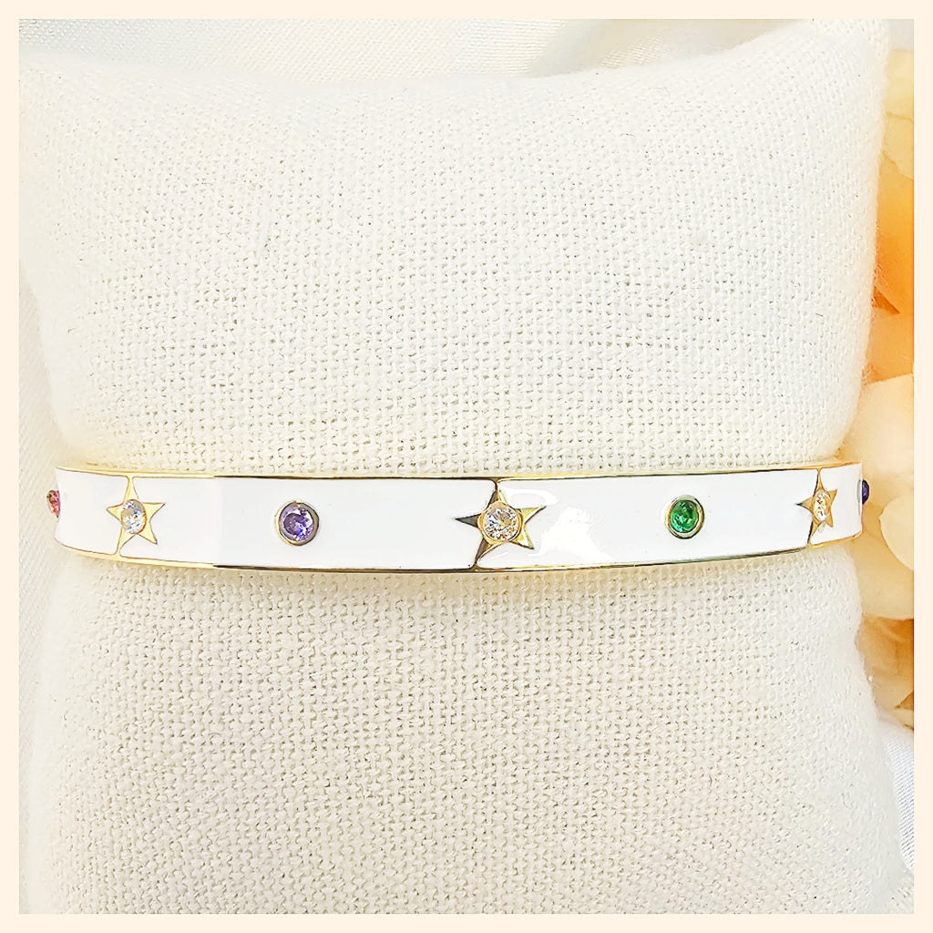 Kaya white star twist cuff bangle in gold and silver tones, ideal for mixing metals and elevating everyday style with effortless shine.