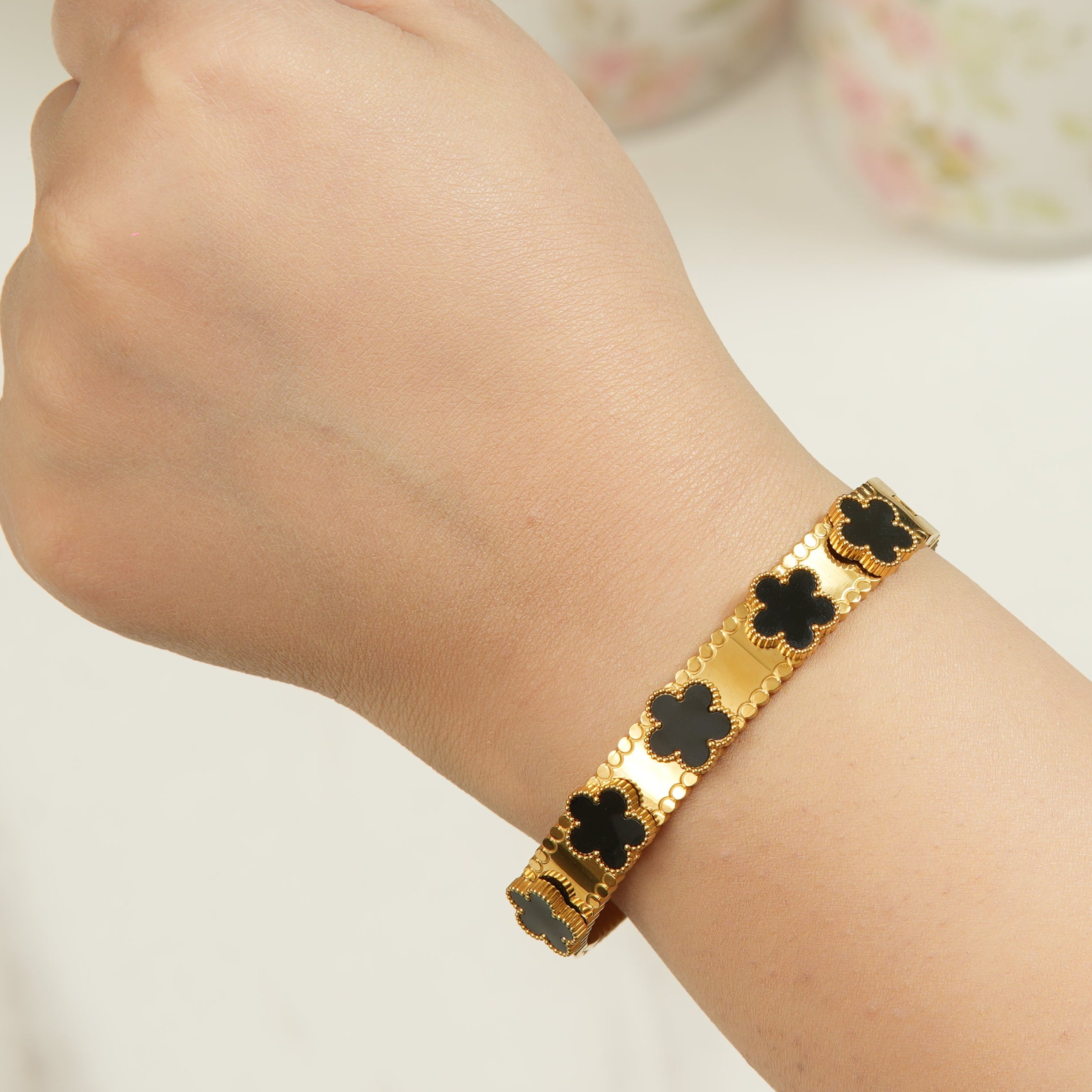 Keia clover petal crystal bangle bracelet in 18K gold-plated finish, a refined openable style that adds elegant brilliance to day and evening looks.