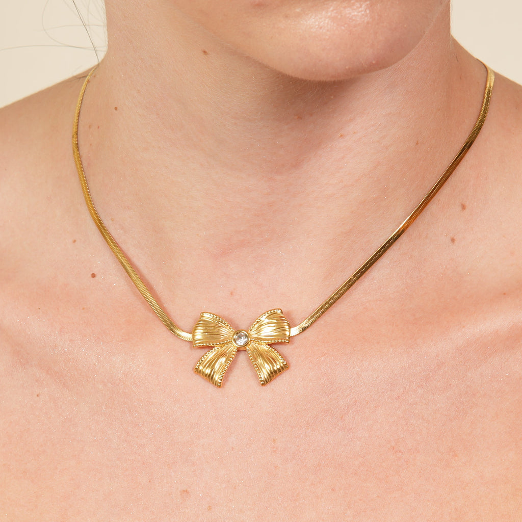 Lala bow stone necklace in a gold-plated dainty choker style, a trendy bow pendant piece designed to add soft luxury and feminine charm in the UAE.