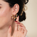 Lisa pearl hoop earrings for women with a gold-tone twisted design and large pearls, created to bring elegant glamour and confident shine to UAE styling.