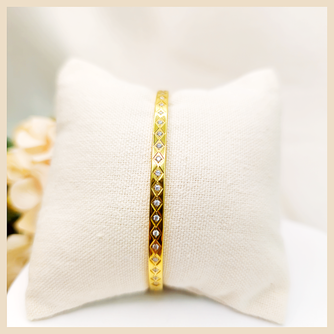 Luxury Bana geometric cuff bracelet in gold-plated shine, perfect for women who want a standout statement accessory with a polished, high-end finish.