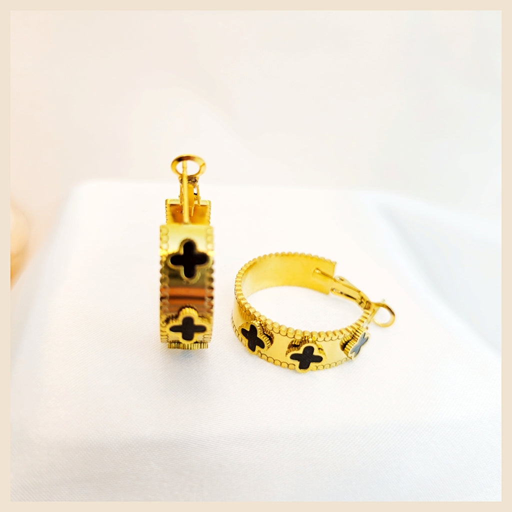 Luxury Dana clover hoops with heart zircon sparkle, styled for Dubai-inspired looks when you want understated glamour that still feels exclusive.