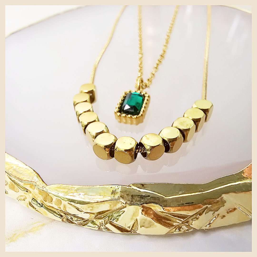 Moon and butterfly medallion layered necklace with a delicate gold tone, expressing femininity, confidence, and refined taste.