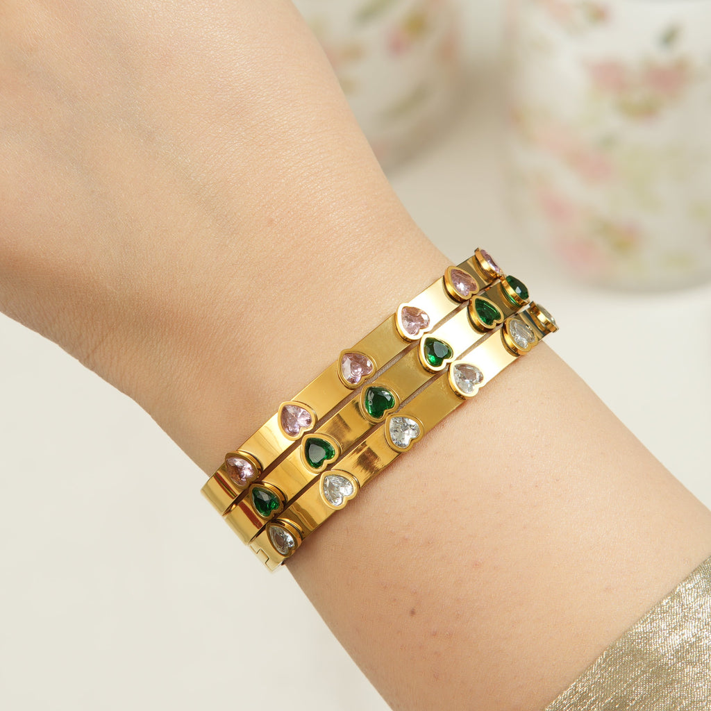 Open clasp gold bangle with sparkling cubic zirconia, shown against a sleek background to highlight its modern, premium appeal for UAE shoppers.