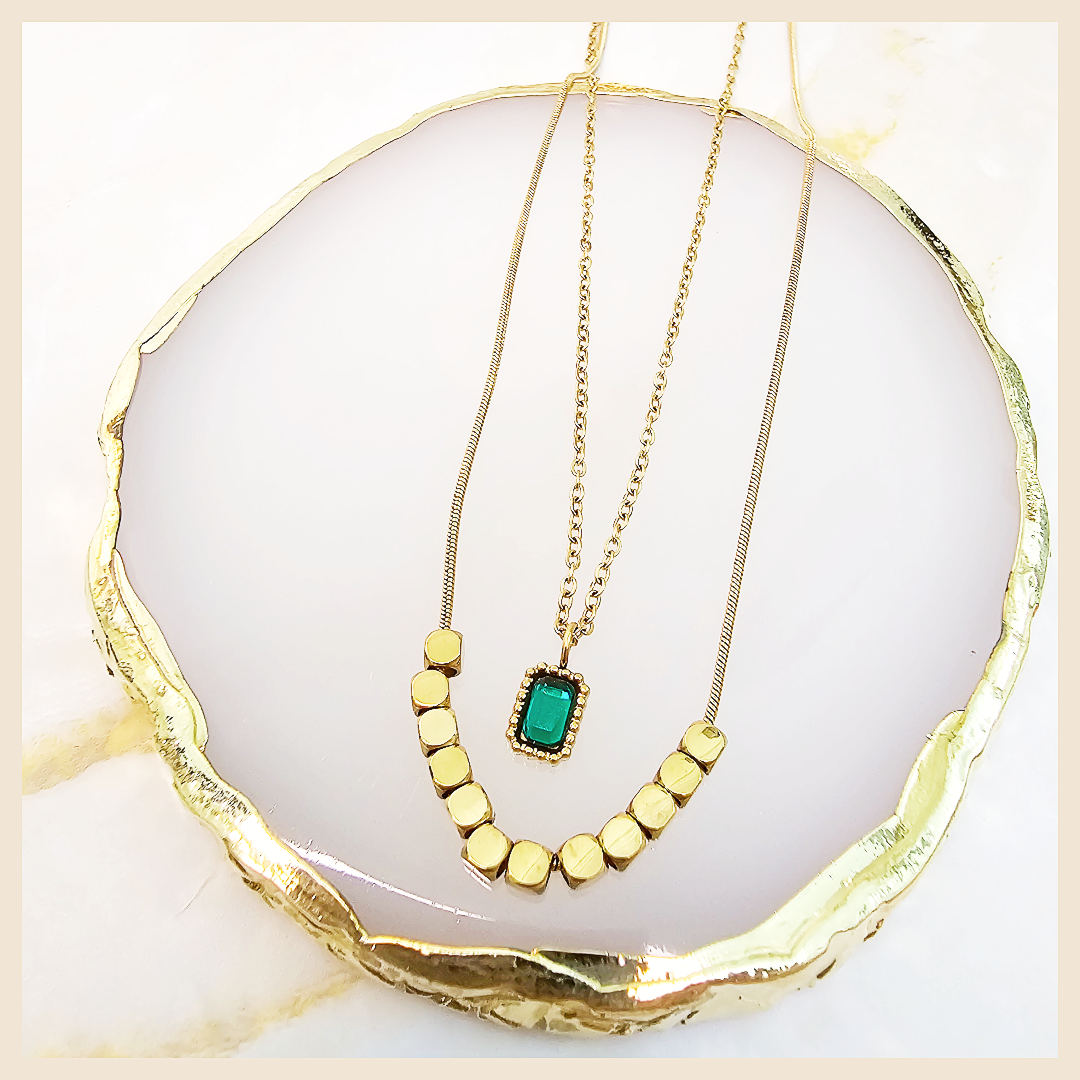 Layered necklace featuring pearl, bar, and coin disc elements, created to add sophistication and soft glamour to any outfit.