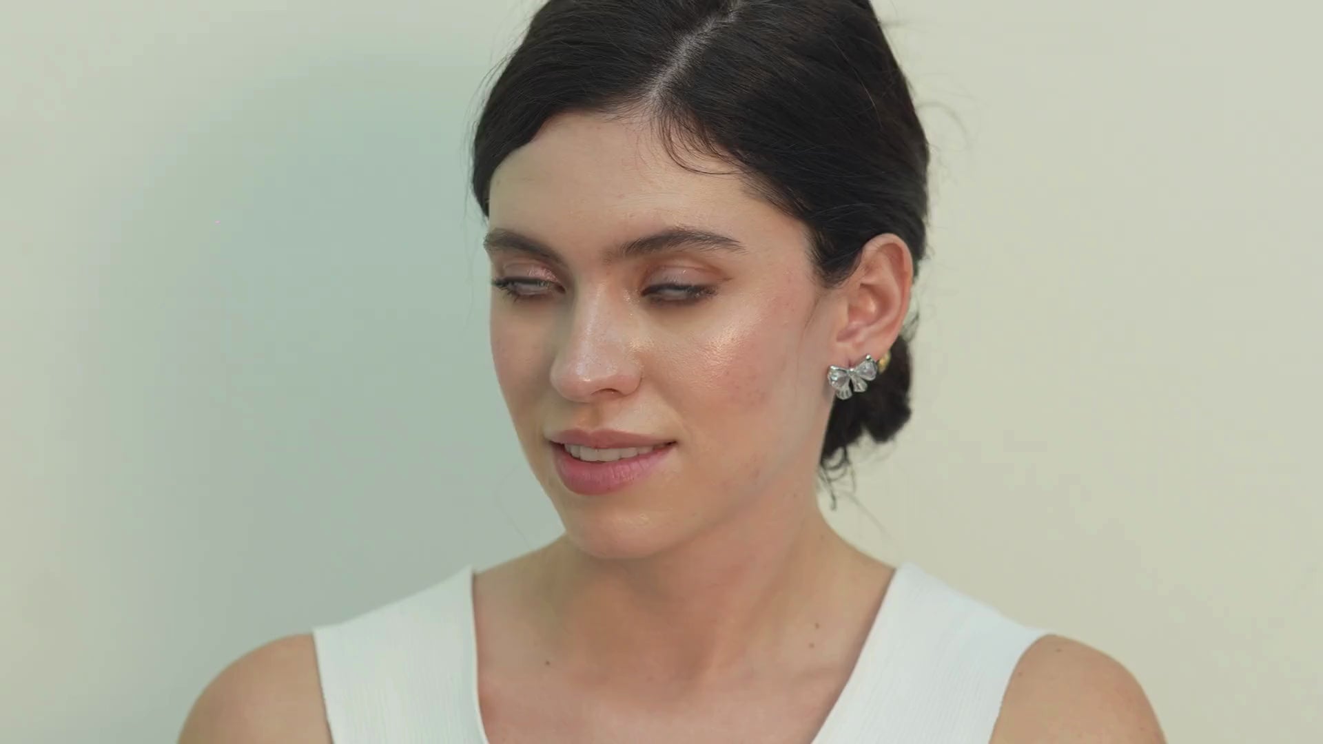 Elegant Cadi bow knot drop earrings in a silver huggie style, designed to bring refined glamour and confidence to party and occasion looks.