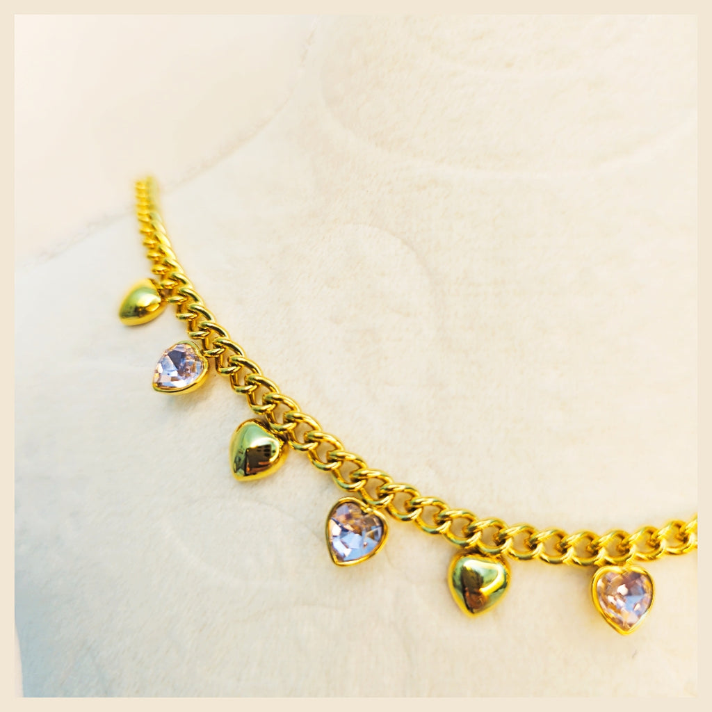 Gold satellite chain heart necklace designed for a refined feminine look, blending modern luxury with a light, graceful feel suited for everyday wear.