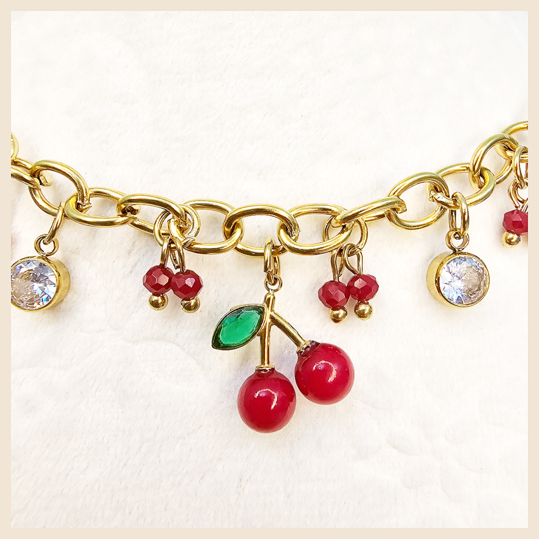 Sparkling Bina cherry pendant necklace with an asymmetrical zircon design, crafted to bring joyful glamour and a stylish statement to everyday looks.