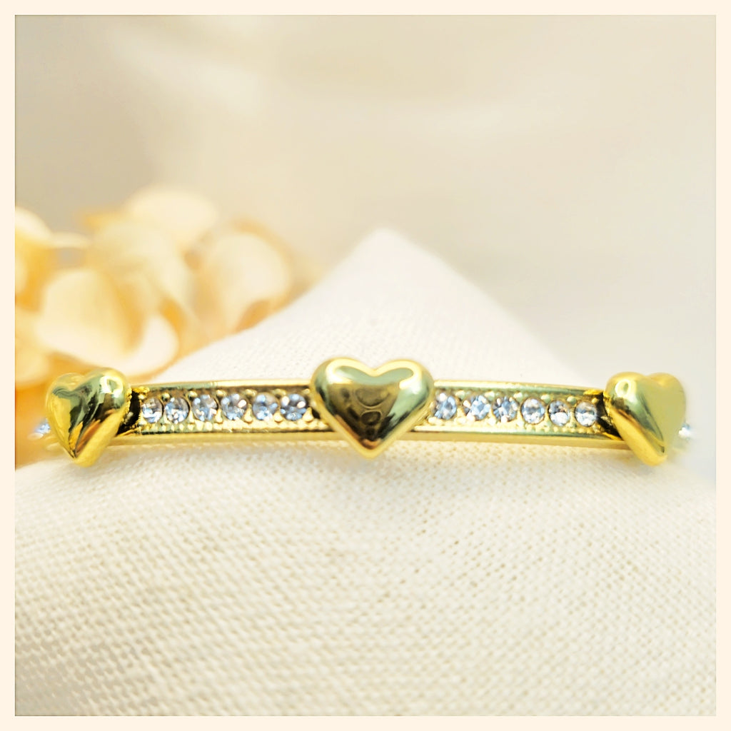 Stackable artisan bangle in gold, designed to layer elegantly for weddings, parties, or upscale everyday wear, offering a confident, elegant look.